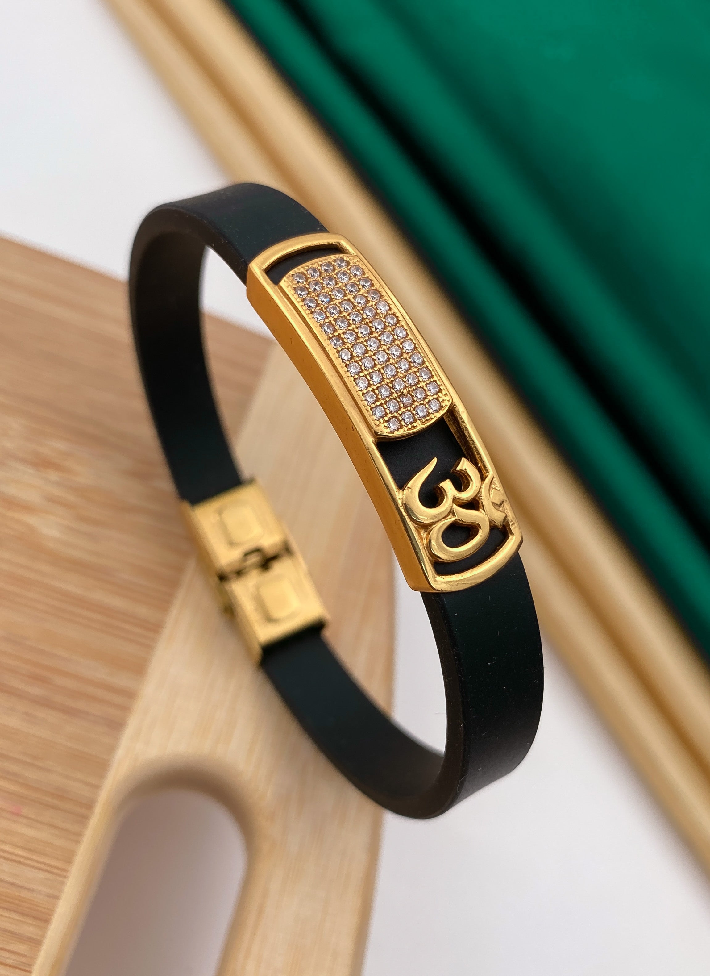 Side om gold plated diamonds in black silicone bracelet for men